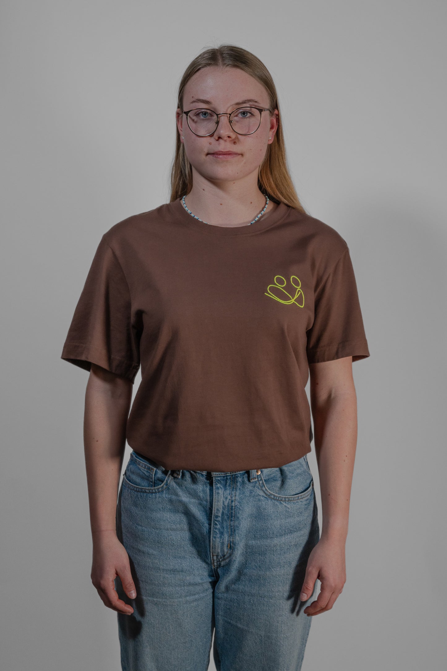 brown T-shirt with yellow embroidery
