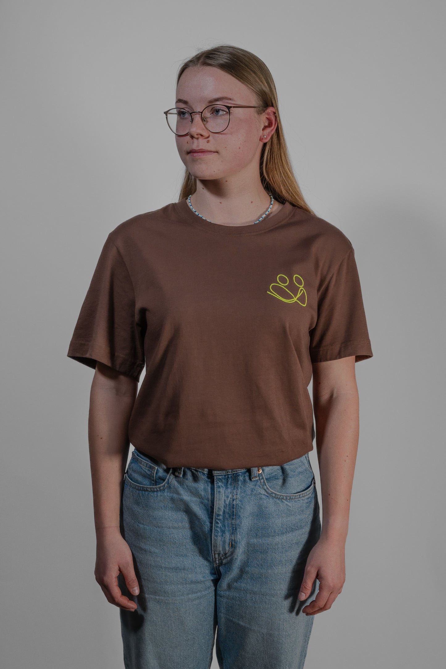 brown T-shirt with yellow embroidery