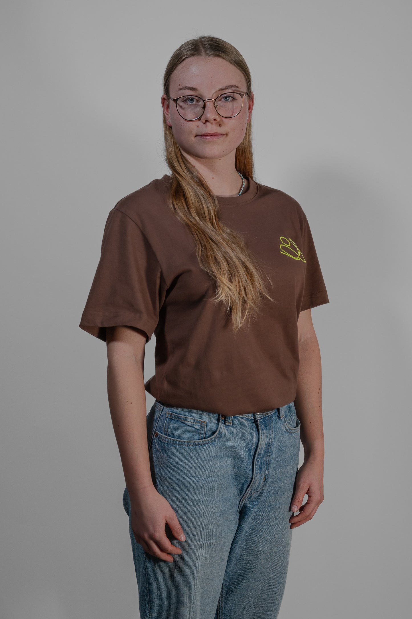 brown T-shirt with yellow embroidery