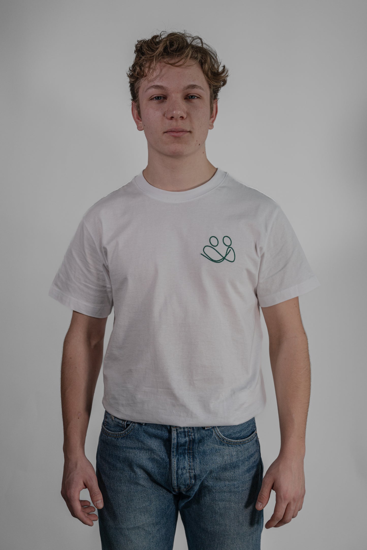 white T-shirt with green embroidery