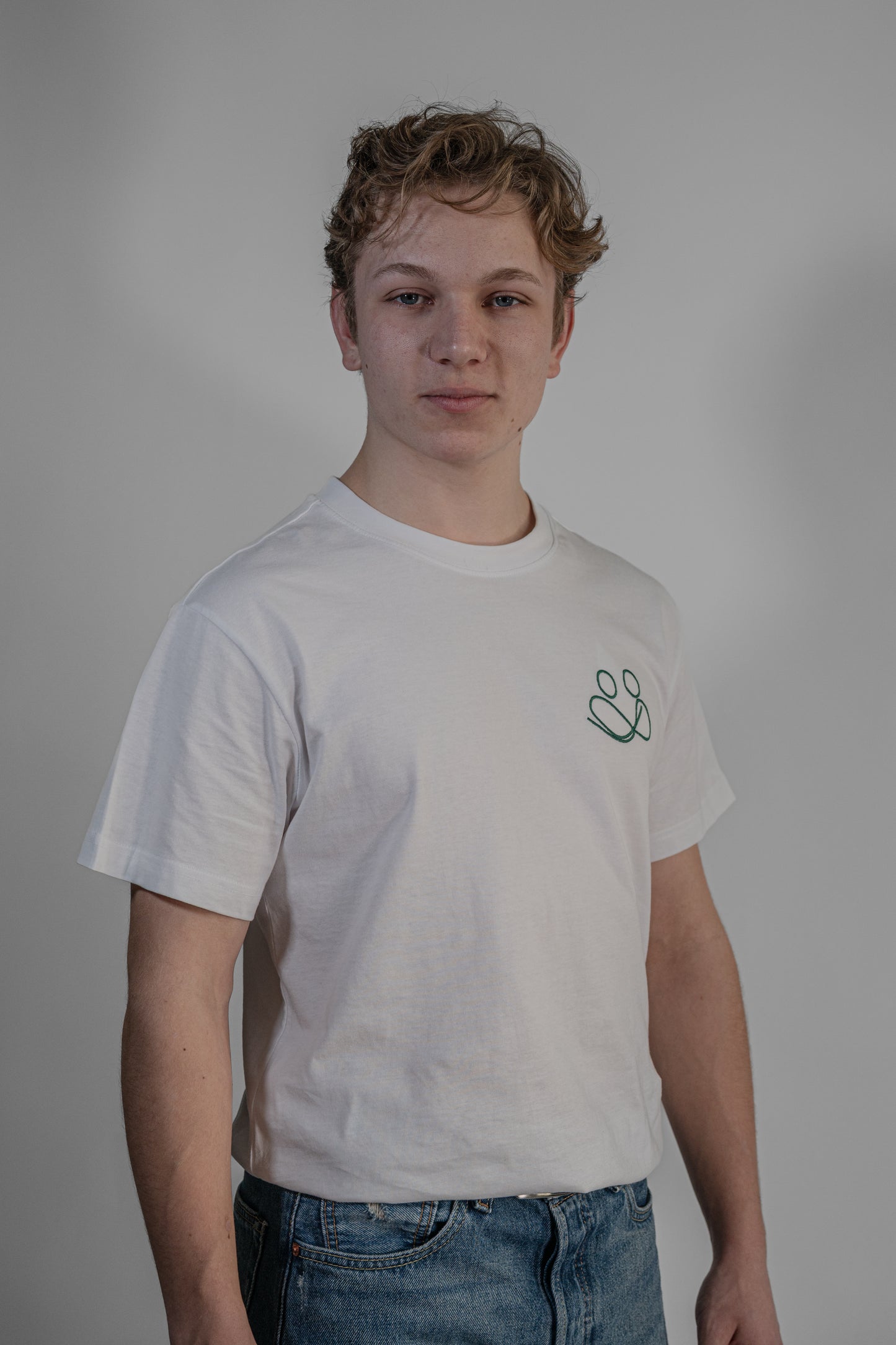white T-shirt with green embroidery