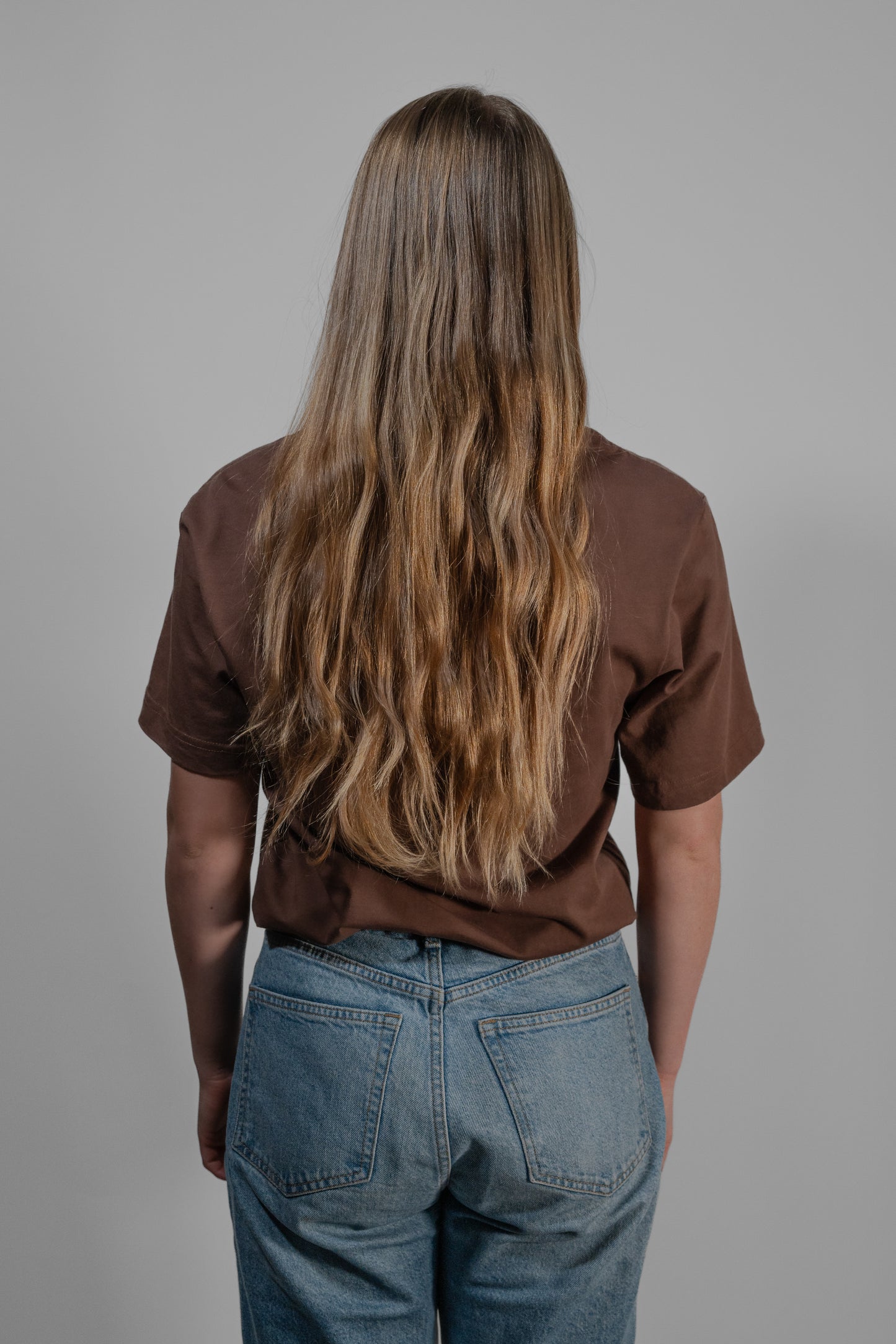 brown T-shirt with yellow embroidery