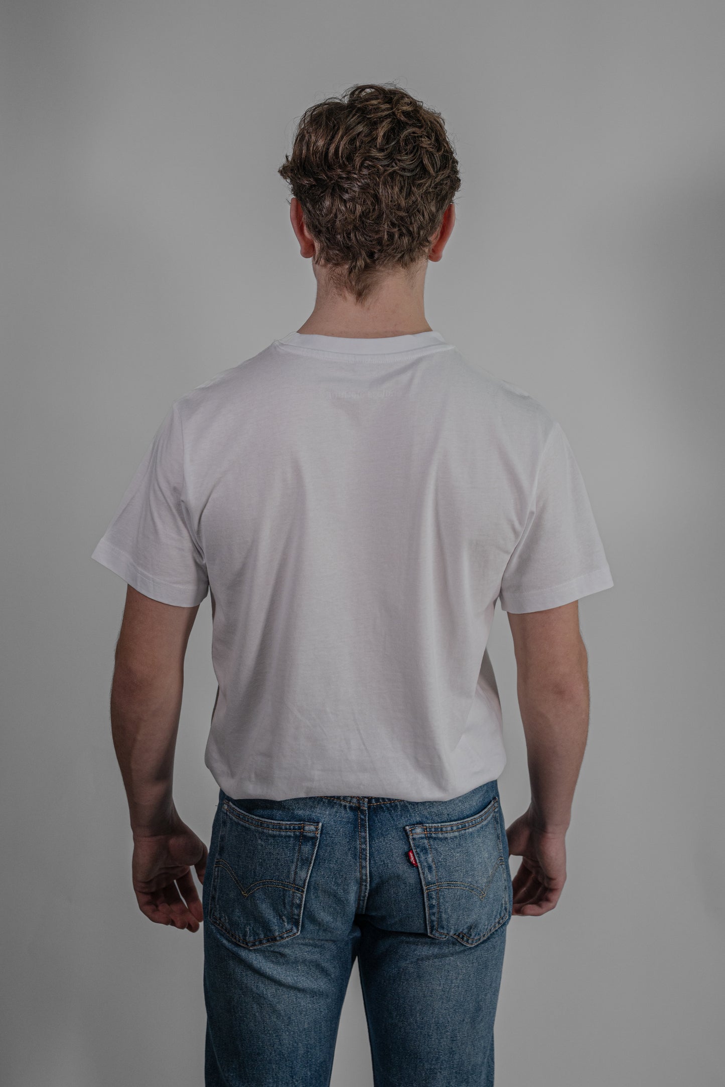 white T-shirt with green embroidery