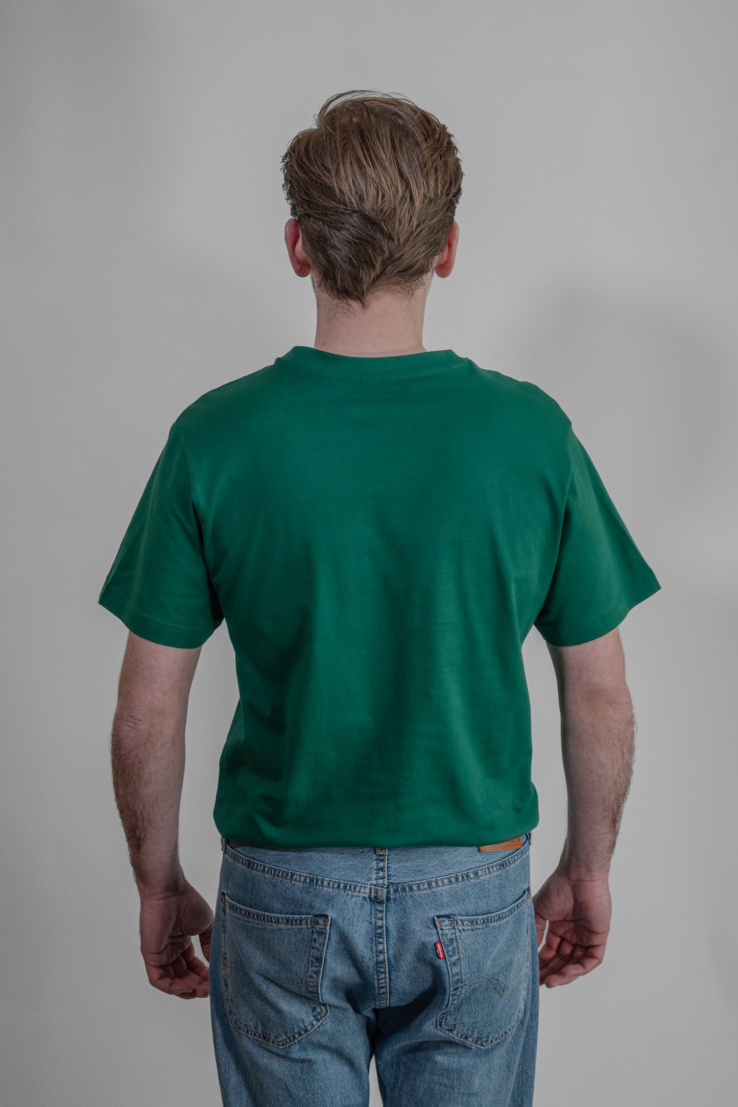 green T-shirt with orange embroidery